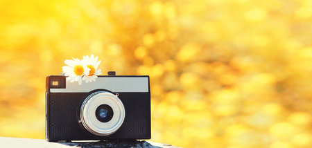 Close up vintage film camera on sunny summer bokeh backgroundの写真素材