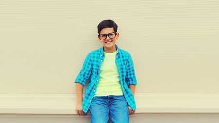 Happy smiling teenager boy in eyeglasses, casual shirt posing on white backgroundの写真素材