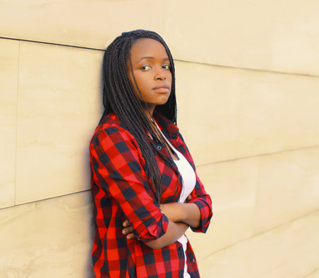 Portrait of beautiful young african woman posing wearing casual in the city