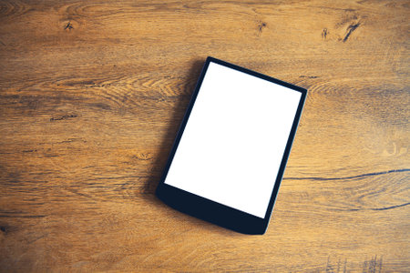 White blank screen digital tablet computer on wooden table at home, top viewの写真素材
