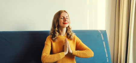 Calm relaxed healthy young woman meditates, girl practicing doing yoga exercises sitting in lotus...