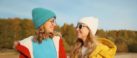 Portrait of happy young two women friends together on sunny beach, stylish smiling girlfriends...