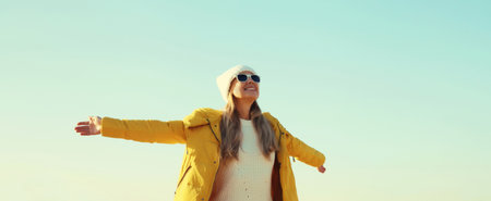 Happy smiling woman raising her hands up on sunny beach, enjoying amazing landscape, warm weather,...