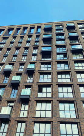 Architecture and real estate, residential apartment building with large panoramic windows, modern complex, urban backgroundの写真素材