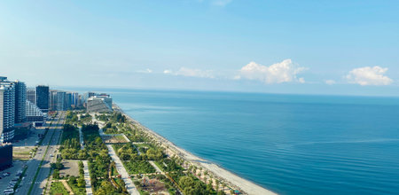 Beautiful green public park, sea coast with beach and blue sky. Batumi, Georgia. Aerial viewの写真素材