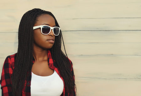 Fashionable portrait of young African woman in casual clothing, stylish modern girl in sunglasses...