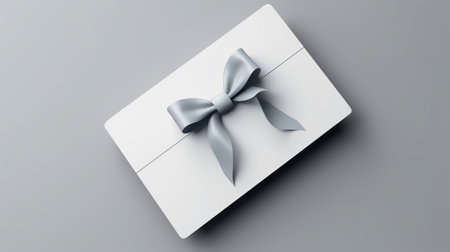 Blank white gift card with blue ribbon bow isolatedの素材