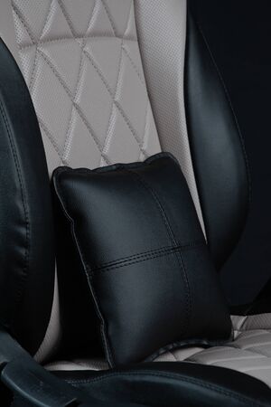 close up of a leather black and peach car seat cover