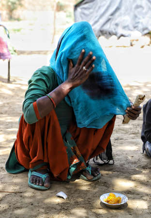 sirsa,haryana,needy women eating food during lockdown in India due to Corona Virus Pandemic.