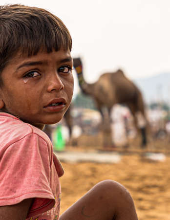 close up portrait of little rajasthani boy at pushkar camel festival.のeditorial素材