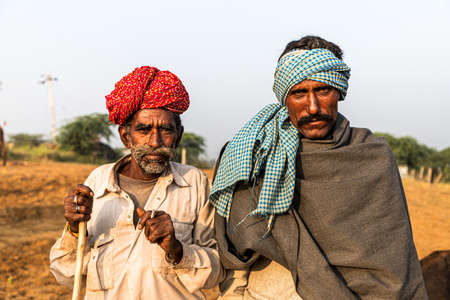 portrait of two man smoking at pushkar camel festival.のeditorial素材