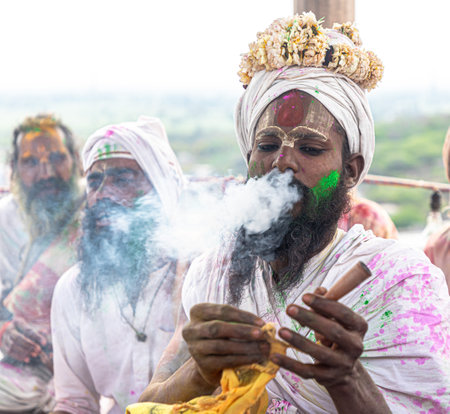 people celebrating holi at barsana on holi festival with selective focus on subject and added noise and grains.のeditorial素材