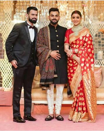 Virat kohli and Anushka sharma during Delhi reception in November 2017 after their marriage in Italy  kohli is Indian outstanding batsman  after long affair he married to Bollywood actress Anushka sharma  he is wearing black shirt and she is wearing red bのeditorial素材