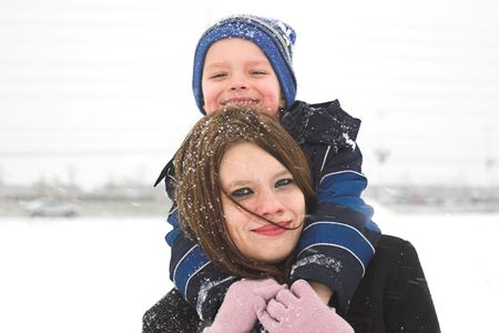 A mother and son have the time of their life playing in the snowの写真素材