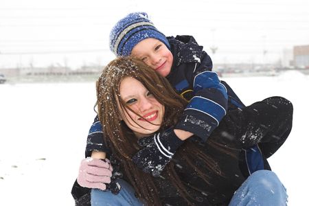 A mother and son have the time of their life playing in the snow