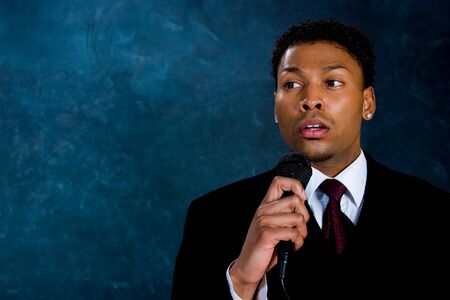 An African American man in a business suit makes a speech.の写真素材