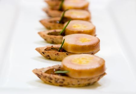 Torched foie gras and confit tian, layered with Manitoba wild rice and maple salad.の写真素材