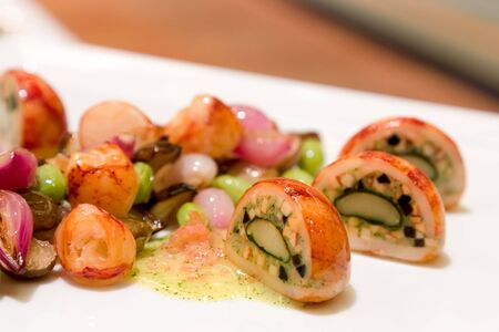 Stuffed Quail egg, fried and served with onions and seasonal vegetablesの写真素材