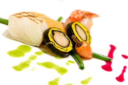 Lobster covered with scallop mousse, maple roasted artic char and pan seared sea bass. Served with grilled shrimps and salmon filet.の写真素材