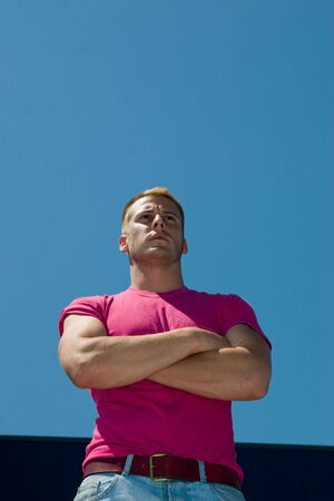 A young caucasian man sitting with a determined look on his faceの写真素材