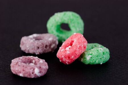 Breakfast Series - Frosted cereal rings against a black background.の写真素材
