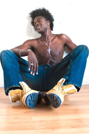 Shot of a young man listening to musicの写真素材