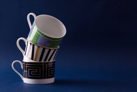 3 assorted cups stacked one on top of the otherの写真素材