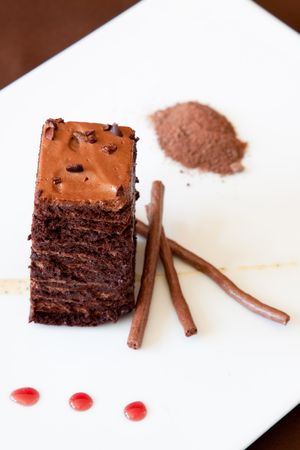 Flourless chocolate sponge dessert made with dark chocolate mousse, black pepper, creme anglaise,...