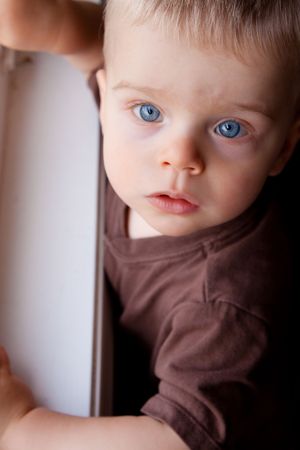 A caucasian blue-eyed child looks up at wonder. Shallow DOF for effect.の写真素材