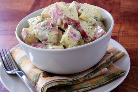 Delicious creamy potato salad dressed in mayo infused with dijon mustard.の写真素材
