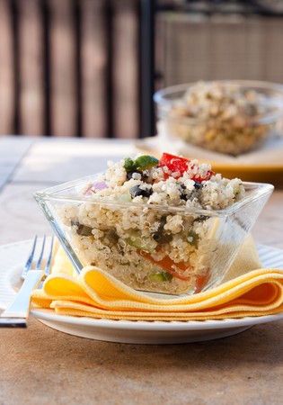 Nutritious and delicious salad made from Quinoa grains, feta cheese, olives, tomatoes, green peppers, celery, onions, and select spicesの写真素材