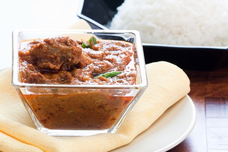Tender pieces of marinated lamb cooked in traditional Indian spices. Served with steamed rice.の写真素材