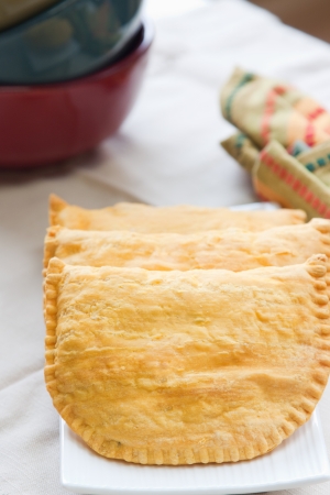 Three Jamaican beef patties on a plateの写真素材