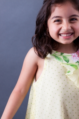 A beautiful girl child laughs as she looks at the cameraの写真素材
