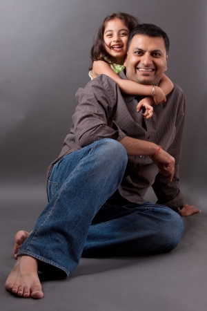 Portrait of an East Indian man laughing with his daughterの写真素材