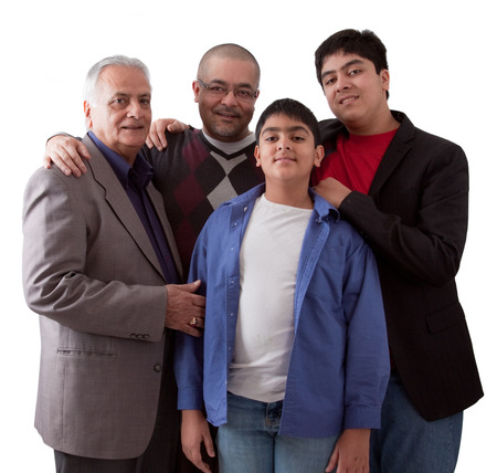 An extended Indian family of grandfather, son and grandsons in a studio settingの写真素材