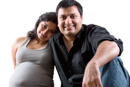 Image of an East Indian man with his pregnant wifeの写真素材