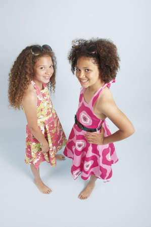 Two mixed race girls together in summer dressesの写真素材