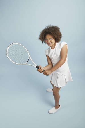 Mixed race young tennis girl ready to playの写真素材