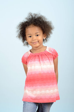Three quarter length portrait of young mixed race girlの写真素材
