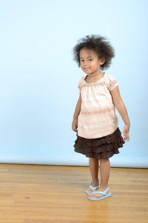 Standing posed girl in brown skirtの写真素材