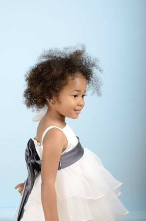 Little girl in formal dress from the sideの写真素材