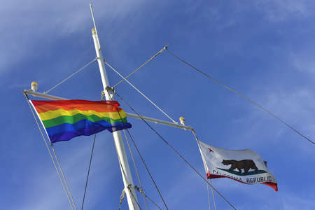 The rainbow banner flies alongside the banner of California Republic on the mast of a yachtの写真素材