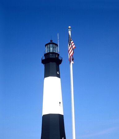 A lighthouse and U.S. flag.の写真素材
