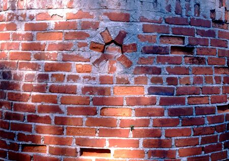 old red brick circular wall with holeの写真素材