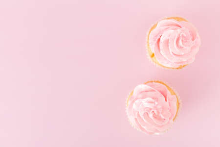 Cupcake with pink cream decoration on pink pastel background - romantic horizontal banner for...