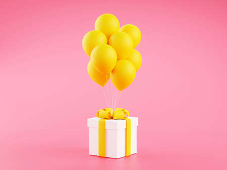 Gift box with yellow ribbon and balloons on pink backgroundの写真素材