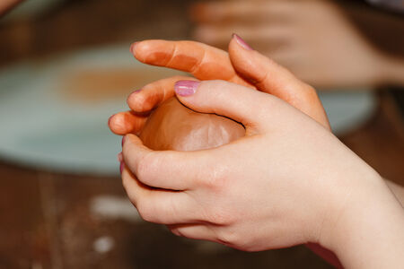 Clay blank in the hands of masters in the hands