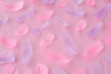 Beautiful soft pink purple feathers and fluff on pink background. Abstract modern festive, love, valentines day, romantic, easter backgroundの写真素材