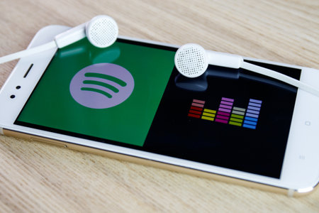 Spotify and Deezer mobile phone applications. Spotify and Deezer are two biggest music streaming platformsのeditorial素材